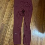Lululemon 7/8 cropped leggings in a reddish color a bit warmer than maroon. Photo 2