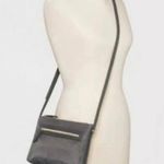 A New Day Crossbody Bag with Portable Charger. Photo 1