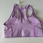 Fabletics On-The-Go Medium Impact Sports Bra small purple cosmo/ pink escape Photo 6