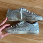 Golden Goose Super-Star Iridescent and Glitter Leather Sneakers - Sz 38 - US 7 1/2 These are in good condition with light wear throughout. They are a pretty hard to find but super cute style. They have like holographic leather and glitter areas. Please see pics for details. Metallic leather upper Round toe Lace-up closure White leather star Cushioned insole; unlined Rubber sole Made in Italy Photo 8