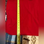 Calvin Klein 's sleeveless red top features a black tie neckline Photo 7