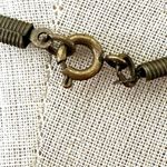 Green and gold tone pendant necklace on black cord Photo 6