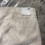 Forever 21 Mid-Rise Raw-Cut Denim Shorts
Size 34
Color is light beige
Brand is  Photo 4