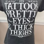 Port & Company Tattoos, Pretty Eyes, and Thick Thighs Short Sleeve Graphic Tee Size Medium Photo 1