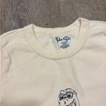 Brandy Melville  ashlyn cream baby tee with baby dinosaur costume graphic Photo 1