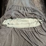 Altar'd State flowy, A-line maxi dress with a tiered skirt and a deep V-neckline or open-back design. Photo 3