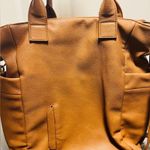 Brown patent leather diaper bag with multiple pockets and key holders Photo 7