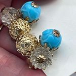 Vintage Vogue ornate clip on earrings. Ab and blue glass . Gold Photo 1
