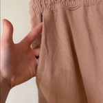 Free People movement dusty rose colored joggers with ankle zip and drawstring Photo 9