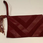 Carlos Santana  burgundy clutch Photo 0