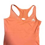 Adidas Stay stylish and comfortable with the  Women's Orange Tank Top. Perfect for workouts or casual wear, this top offers a vibrant look and a great fit. Photo 2