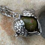 Unakite confidence gemstone in a heart shaped necklace cage. 36” chain Photo 1