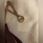 Michael Kors  Deep Chocolate Brown Tassel hang tag with Gold Hardware. Photo 1