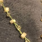 Light yellowish green teardrop stone with little stones and beads chain clasp Photo 1