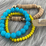 Set of three stretch bracelets glass, shell and gold colored metal. Blue Photo 0