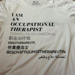 FIGS  White I AM AN OCCUPATIONAL THERAPIST Multilingual Graphic Tee Shirt Size S Photo 3