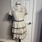 Shoshanna Stacia Lace Tiered Polka Dot Knee Length High Neck Black trim on neck/sleeve/bottom Hidden back zipper A flutter sleeve ballet lace fit-and-flare mini dress with ruffle detail below the waist ivory cream Kentucky Derby mock sheer layer Photo 4