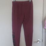 PINK - Victoria's Secret  sweatpants with pink pink on left bottom leg in burgundy red and black in small. Photo 5