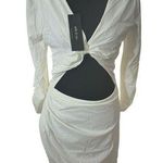 Short white dress with a modern and elegant design. It features long sleeves, Size M Photo 0