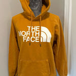 The North Face  Women’s Sz: M Hoodie Sweatshirt Mustard Yellow Logo Pullover. Photo 0