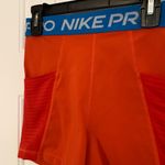 Nike Pro Bright Orange Shorts with Blue Waistband Photo 1