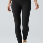 Halara 025HA.-  SoCinched High Waisted Tummy Control Pocket Shaping Training Leggings. Photo 1