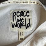 Peace Love World  Cream Oversized Sweater with Rainbow Stripes Photo 1