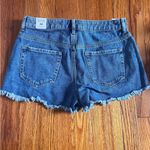 PacSun Medium to dark wash jean shorts with some rips. Photo 1