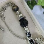 Silver and Black Charm Necklace Mixed Media Photo 5