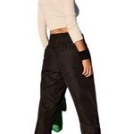 Free People Movement NWT--THE WAY HOME JOGGERS-BLACK-SIZE SMALL-MSRP $60 Black joggers, wide smocked waistband, pull on style, front hip pockets, 100% nylon, brand new with tags Measurements: Waist: side to side 14-17 inches Inseam: 28 inches  Photo 2