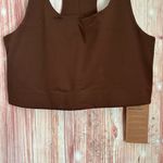 Girlfriend Collective • Designed for medium impact activities • Double lined, sweat-wicking material with four way stretch • Racerback • Scoop neck • Built-in support band • Form-hugging fit • Poly/spandex blend Photo 4