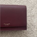 Kate Spade  Maroon Crossbody Bag with Gold Chain Strap. Photo 3