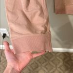 Free People movement dusty rose colored joggers with ankle zip and drawstring Photo 1