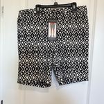 Mario Serrani Stylish bermuda shorts with a bold geometric design. Perfect for casual wear. NWT   Brand:  Italy • Material: A comfortable stretch blend, 76% rayon, 21% nylon, and 3% spandex. • Design: Feature a built-in tummy control panel for a flattering fit, front side seam slanted pockets, a zipper fly with a hook-and-bar closure, and faux back pockets. • Inseam: 9-inch inseam. - Length 18 inches  • Pattern: The shorts  feature a distinct black and white geometric or diamond print. Photo 2