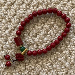 Red Beaded Bracelet With Chinese Design and Small Green Bead Photo 0