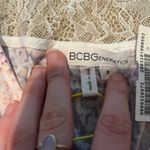 BCBGeneration Light pink and purple patterned long sleeve romper with lace back never worn  Photo 3