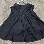 LA Made This chic sundress by Anage features a pleated design in classic black and white, perfect for a casual night out. The sleeveless silhouette with spaghetti straps and a mini length adds a playful touch to your ensemble. Its versatile style makes it a must-have for any wardrobe. Photo 4