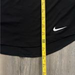  black and white  tank top. Features white Nike logo and straps. Photo 4