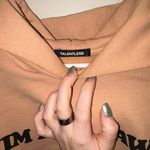 Talentless  Peach Sweater with Black Text Photo 1