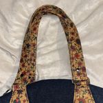 BLUE DENIM HANDBAG WITH FLORAL CORKLIKE DESIGN ON BOTTOM & HANDLES RED INTERIOR Photo 6
