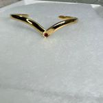 Avon gold tone V shaped cuff bracelet with faux ruby or garnet. Large Photo 1
