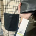 Calvin Klein $159 checkered long Cardigan cream jacket leather pockets long sleeve leather cuff adjustable waist tie padded shoulder size 4 NWT New with tag Same day shipping Smoke and pets free Elevate your winter wardrobe with this stunning checkered cardigan jacket. Crafted with high-quality polyester, this long overcoat comes with leather pockets for added convenience. The jacket boasts a unique check pattern that is sure to turn heads wherever you go. This padded jacket is perfect for cold winter nights and comes with a strap accent that adds a touch of sophistication to the overall design. Available in size 4, this jacket is perfect for women who prefer a regular fit. Don't miss out on this must-have cold weather essential! Photo 4