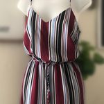 Wide leg long palazzo style burgundy, blue and white striped jumpsuit with adjustable straps and a tie waist. Photo 1