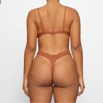 SKIMS NTW/ FITS EVERYBODY LACE TRIANGLE BRALETTE, Color bronze tan. Photo 1
