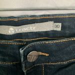 Tractr: Stretchy Skinny Jeans with red flannel covered holes Photo 1