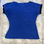 Jaclyn Smith  Blue and Black Top With a Tie Up Bow On The Side Photo 3