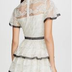 Shoshanna Stacia Lace Tiered Polka Dot Knee Length High Neck Black trim on neck/sleeve/bottom Hidden back zipper A flutter sleeve ballet lace fit-and-flare mini dress with ruffle detail below the waist ivory cream Kentucky Derby mock sheer layer Photo 1