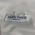 Alyn Paige Long Dress: Elegant 90’s sleeveless dress features A-line silhouette, perfect for any occasion. The delicate fabric drapes beautifully, providing a flattering fit. This timeless piece can be dressed up or down, making it a versatile addition to your wardrobe. Ideal for summer gatherings or evening events, it's a must-have for style enthusiasts. Photo 3