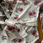 Gimmicks by BKE Gimmicks Floral and Snake Print Wrap Top Photo 1