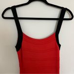Sexy Black and Orange/Red crisscross back stretch knit dress. Photo 1